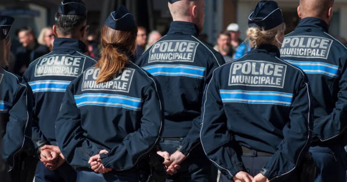 Des policiers municipaux de dos, mains croisées dans le dos
